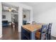 Charming dining area with hardwood floors, a stylish table, and a view of the living room at 5316 Radford Loop, Fairburn, GA 30213