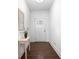 Bright entryway features hardwood floors, a charming table with flowers, and a decorative mirror at 5316 Radford Loop, Fairburn, GA 30213