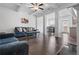 Spacious living room with hardwood floors, a fireplace, and a view into the dining area at 5316 Radford Loop, Fairburn, GA 30213