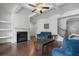 Cozy living room featuring a fireplace, built-in shelving, and comfortable seating at 5316 Radford Loop, Fairburn, GA 30213