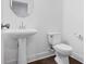 Clean powder room featuring a pedestal sink, toilet, and fresh white walls at 5316 Radford Loop, Fairburn, GA 30213