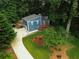 An aerial view of a blue house, lush green lawn and a long driveway leading to the home at 674 Crespan Ct, Lawrenceville, GA 30044