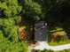 Aerial shot showcases a home with a dark roof, surrounded by lush green trees at 674 Crespan Ct, Lawrenceville, GA 30044