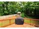 Spacious backyard with a well-maintained wooden deck and covered grill, perfect for entertaining at 674 Crespan Ct, Lawrenceville, GA 30044