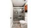 Tiled shower stall with glass door and dark cabinetry in bathroom at 674 Crespan Ct, Lawrenceville, GA 30044