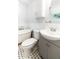 A cozy bathroom with a gray vanity, modern round mirror and classic tub at 674 Crespan Ct, Lawrenceville, GA 30044