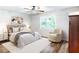 Comfortable bedroom features a plush bed, a ceiling fan, natural light, and elegant decor, creating a relaxing atmosphere at 674 Crespan Ct, Lawrenceville, GA 30044