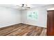 An airy bedroom featuring wood-look floors, a modern ceiling fan, and abundant natural light at 674 Crespan Ct, Lawrenceville, GA 30044