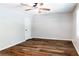 Spacious bedroom with hardwood floors, natural light, and a ceiling fan at 674 Crespan Ct, Lawrenceville, GA 30044