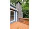 Exterior view highlighting a stone chimney and deck with natural wood railings at 674 Crespan Ct, Lawrenceville, GA 30044