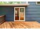 Exterior view of home featuring a wooden deck, and sliding doors to the back yard at 674 Crespan Ct, Lawrenceville, GA 30044