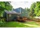 Exterior view featuring a wooden deck, lush lawn, and a charming blue house at 674 Crespan Ct, Lawrenceville, GA 30044