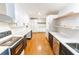 Galley kitchen with white cabinets, stainless steel appliances, and quartz countertops at 674 Crespan Ct, Lawrenceville, GA 30044