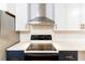 Modern kitchen features stainless steel appliances, white cabinets, and subway tile backsplash at 674 Crespan Ct, Lawrenceville, GA 30044