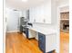 Modern kitchen with white cabinets, stainless steel appliances, and hardwood floors at 674 Crespan Ct, Lawrenceville, GA 30044