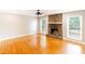 Spacious living room boasts a stone fireplace and gleaming hardwood floors at 674 Crespan Ct, Lawrenceville, GA 30044