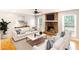 Bright living room features a stone fireplace, hardwood floors, and neutral decor at 674 Crespan Ct, Lawrenceville, GA 30044