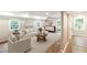 Spacious living room with light-colored sofa, area rug, and view of the backyard at 674 Crespan Ct, Lawrenceville, GA 30044