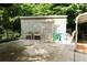 Shed with planters and green bins, located near a carport and surrounded by trees at 674 Crespan Ct, Lawrenceville, GA 30044