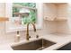 Kitchen sink with subway tile backsplash and a view to the outside at 674 Crespan Ct, Lawrenceville, GA 30044