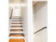 A staircase featuring wood treads and white risers leads to an upstairs level in this home at 674 Crespan Ct, Lawrenceville, GA 30044