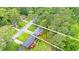 An aerial view shows a home with a dark grey roof, a light colored deck, and is surrounded by mature trees at 2720 Cavalier Dr, Decatur, GA 30034