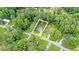 Aerial view of the property surrounded by lush greenery, with outlined lot lines at 2720 Cavalier Dr, Decatur, GA 30034