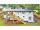Expansive backyard view showcasing a new wooden deck and a painted brick house exterior at 2720 Cavalier Dr, Decatur, GA 30034