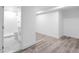 Unfinished basement area with wood-look flooring next to a bathroom with a walk-in shower at 2720 Cavalier Dr, Decatur, GA 30034