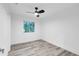 Minimalist bedroom with wood-look flooring, natural light, and neutral paint at 2720 Cavalier Dr, Decatur, GA 30034
