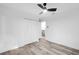 Bright bedroom features a ceiling fan, light wood floors, and a closet at 2720 Cavalier Dr, Decatur, GA 30034