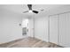 Bright bedroom features a ceiling fan, light wood floors, and a closet at 2720 Cavalier Dr, Decatur, GA 30034