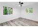 This modern bedroom boasts two windows and light wood floors at 2720 Cavalier Dr, Decatur, GA 30034