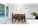 Inviting dining room with modern lighting, wood table set for four, and sliding doors to the deck at 2720 Cavalier Dr, Decatur, GA 30034