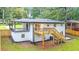 Rear exterior view of home with patio and deck. Landscaped yard with new fence at 2720 Cavalier Dr, Decatur, GA 30034