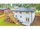 Rear exterior view of a two-story home with a new deck and fenced yard at 2720 Cavalier Dr, Decatur, GA 30034