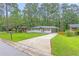 Beautifully landscaped front yard with a freshly painted home and long driveway at 2720 Cavalier Dr, Decatur, GA 30034