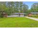 Charming remodeled single-story home featuring lush lawn and modern exterior at 2720 Cavalier Dr, Decatur, GA 30034