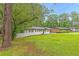 Well-maintained lawn with painted brick exterior home and tree lined neighborhood at 2720 Cavalier Dr, Decatur, GA 30034