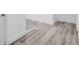 Hallway featuring light-tone wood flooring, white trim, and white walls at 2720 Cavalier Dr, Decatur, GA 30034