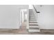A finished hallway with wood-look flooring, access to rooms and stairs to the upper level at 2720 Cavalier Dr, Decatur, GA 30034