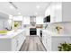 Well-lit kitchen featuring a center island, stainless steel appliances, and white cabinetry at 2720 Cavalier Dr, Decatur, GA 30034