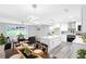 Open living space with modern lighting, dining area, and kitchen with island seating at 2720 Cavalier Dr, Decatur, GA 30034