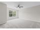 Spacious bedroom with a ceiling fan and large window letting in natural light at 359 Azalea Cir, Cumming, GA 30028