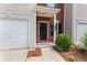Close up on the townhouse entrance, showing brick accents, a black door, and well-maintained landscaping at 359 Azalea Cir, Cumming, GA 30028