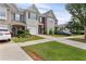Attractive townhome with a single-car garage, complemented by a lush green lawn and driveway at 359 Azalea Cir, Cumming, GA 30028