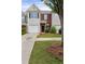 Inviting townhouse with brick accents, lush landscaping, and a well-kept lawn, offering suburban charm at 359 Azalea Cir, Cumming, GA 30028