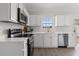 Modern kitchen featuring white cabinets, stainless steel appliances, and stylish countertops at 359 Azalea Cir, Cumming, GA 30028