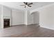 Open-concept living room with hardwood flooring, a fireplace, and neutral paint, perfect for relaxation and entertaining at 359 Azalea Cir, Cumming, GA 30028