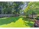 Expansive, well-maintained backyard with lush green grass, mature trees, and landscaping at 366 Coopers Pond Dr, Lawrenceville, GA 30044